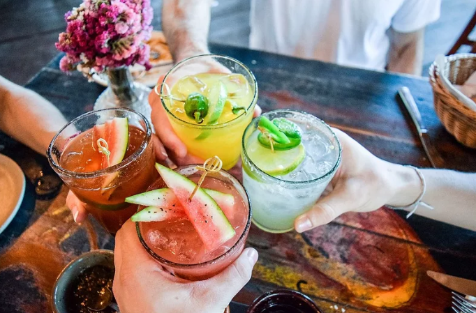 Four drinks being held by four people, trend led flavours including watermelon